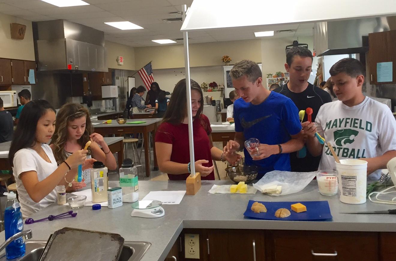 Students in sixth-period consumer science gather ingredients for mashed potato casserole. 