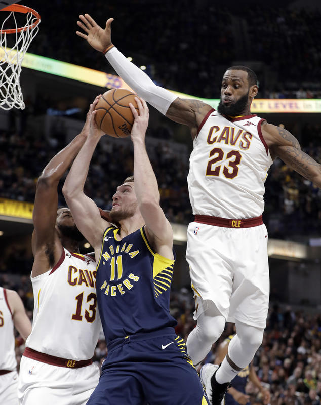 Indiana Pacers' Domantas Sabonis (11) shoots against Cleveland Cavaliers' Tristan Thompson (13) and LeBron James (23) during the second half of an NBA basketball game, Friday, Jan. 12, 2018, in Indianapolis. (AP Photo/Darron Cummings)